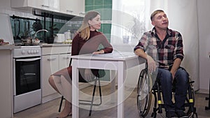 Stressful situation, a disabled person in a wheelchair is depressed during a quarrel with nervous wife, cursing and