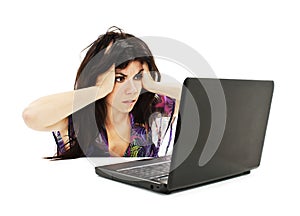 Stressful young woman working on laptop