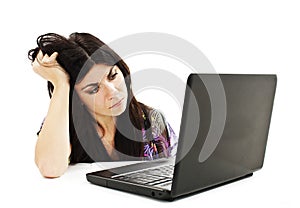 Stressful young woman working on laptop