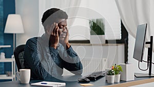 Stressing african american man with big headache pain, suffering from migraine, rubbing his temples