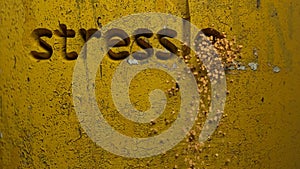 Stressless life word carved in a yellow wall