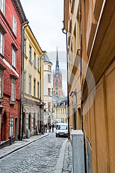 Stret view of the Gamla stan or Staden mellan broarna, with bell tower of  Riddarholm Church, the old town of Stockholm, Sweden