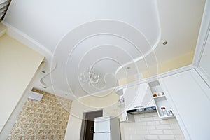 Stretch ceiling in the kitchen. Stretch ceiling white and complex shape