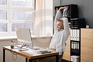 Stretch Exercise At Office Desk. Businessman