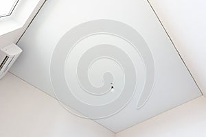 Stretch white ceiling in a rectangular room