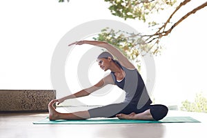 Stretch, yoga and female fitness person in studio, arm and muscle strength on exercise mat. Wellness, activewear and