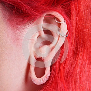 Stretched ear lobe piercing photo