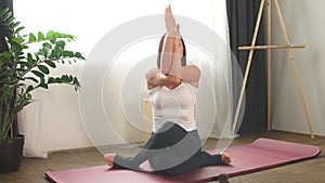 Stretched sporty woman do yoga exercises.