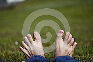 Stretched toes relaxing on Grass photo