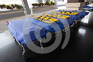 Stretcher bed at walkway in hospital. Empty patient stretcher trolley parked in ward at hospital. Modern hospital equipment.