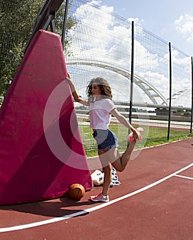 Stretches legs on the basketball court.