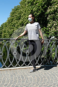 Stretching during coronavirus pandemic with a face mask