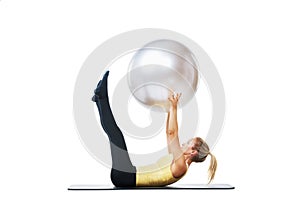 Stretching, exercise ball and fitness woman on a studio floor for legs, strength or training on white background. Gym