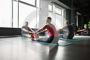Stretching exercises after personal training in gym