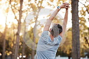 Stretching, fitness and man in park for muscle and body workout, wellness and health in nature with mental health, calm