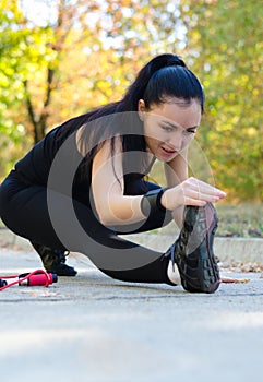 Stretching girl in black leotard