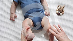 stretching gymnastics exercises with hands and legs of baby infant