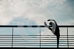 Stretching for muscles before marathon. Silhouette of african american girl, does exercises for legs