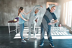 Stretching, physiotherapy and old couple with personal trainer for fitness, wellness and helping. Health, workout and