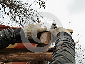 Fastening with staples waterproof material under the roof of a wooden building