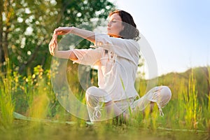 Stretching woman in outdoor exercise smiling happy doing yoga