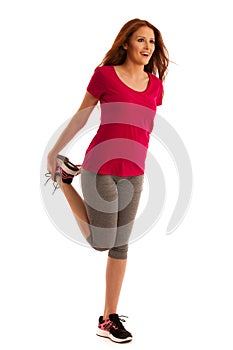 Stretching - woman stretches leg muscles after fitness workout i