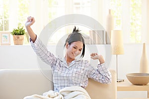 Stretching young woman wearing pyjama