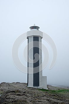 Stretisviti lighthouse on a misty summer evening, Iceland