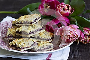 Streusel pie with currant and rose petal filling on a background of tulips.