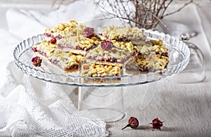 Streusel pie with currant and rose petal filling on a light background.