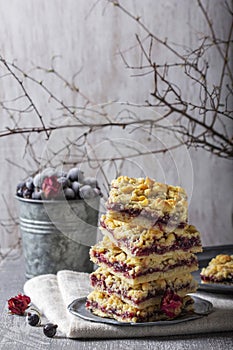 Streusel pie with currant and rose petal filling on a light background.