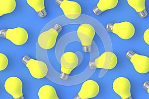 Strewn yellow light bulbs on blue background. Top view