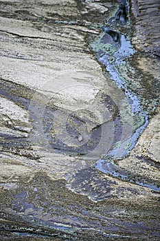 Striated Rock Formations with Acidic Water Channels