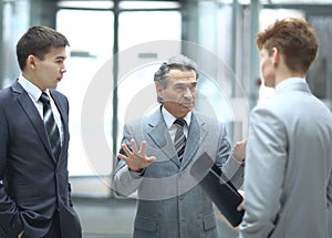 Strict boss talking with an employee.photo on blurred office background