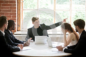 Strict boss telling upset employee to leave room during briefing