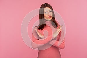 Strict bossy woman with brown hair in pink sweater showing x sign with hands, there is no way more, hopelessness