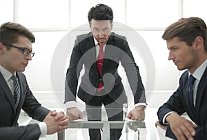 Strict businessman holds a meeting with employees