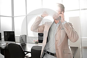 Strict businessman talking on a mobile phone.