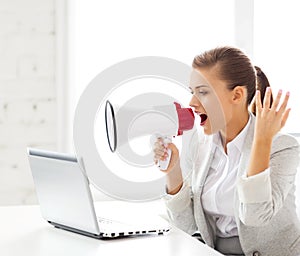 Strict businesswoman shouting in megaphone