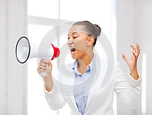 Strict businesswoman shouting in megaphone