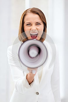 Strict businesswoman shouting in megaphone