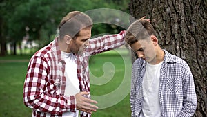 Strict dad scolding son for bad marks at school, parent respect, upbringing