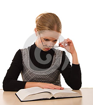 Strict girl reading a book on a white background