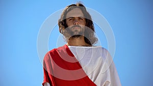 Strict God looking into camera from heaven, upset about sinful life of humanity