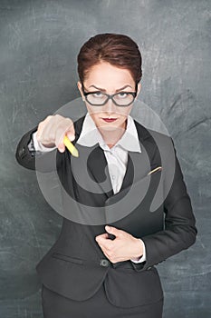 Strict teacher pointing on someone with chalk