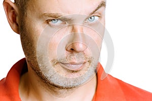 Strict unshaven man on a white background. close up