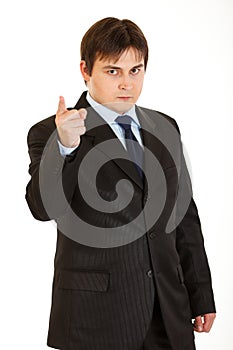 Strict young businessman shaking his finger