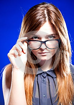 Strict young woman with nerd glasses