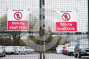 Strictly staff parking only sign on private office car park fence
