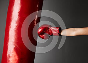 Strike hard and strike fast. Cropped shot of an unrecognizable young female boxer training in the gym.